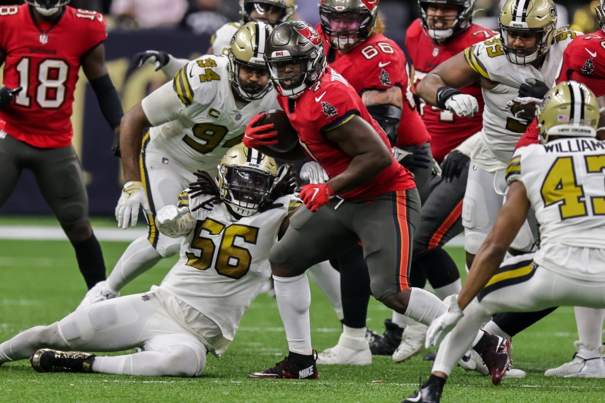 Tampa Bay running back Leonard Fournette (7) against New Orleans Saints linebacker Demario Davis (56). Mandatory Credit: Stephen Lew-USA TODAY Sports
